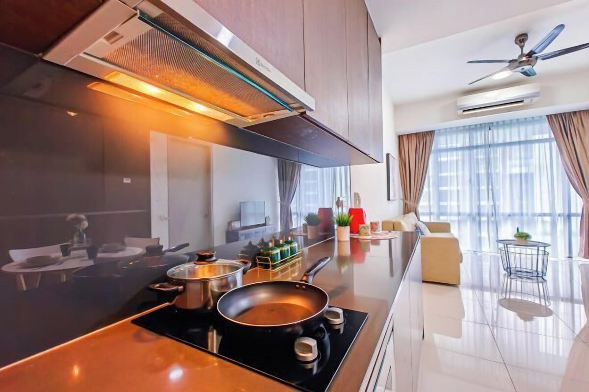 A modern kitchen with a central island, a dining area with a round table, and a living space with a sofa and a coffee table.