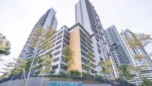 A high-rise building with a prominent sign reading "GRAND MEDIN". - Grand Medini Suites by RR JBcity (Iskandar Puteri)