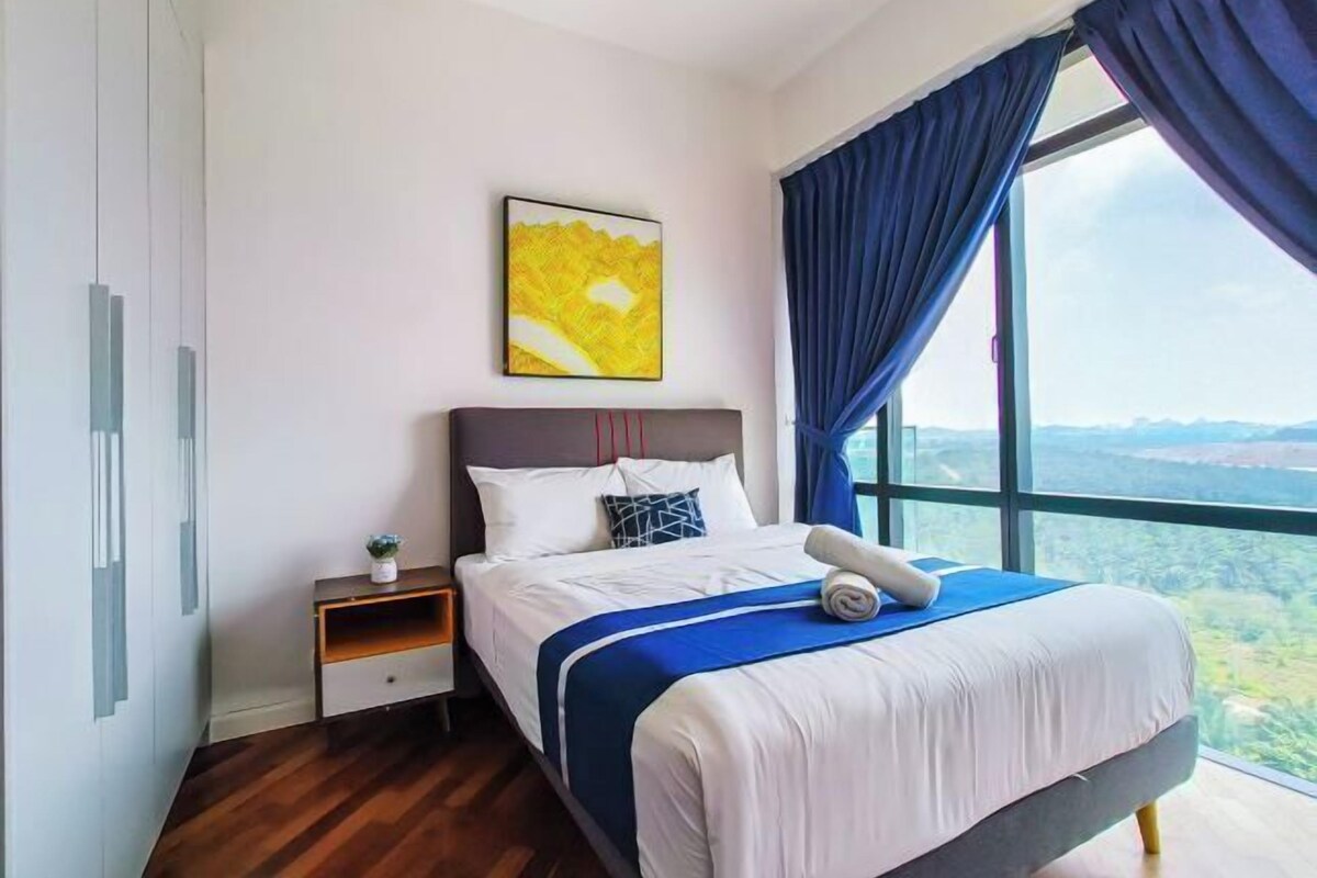 A bedroom with a bed, a nightstand, a painting, and a large window with curtains.
