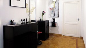 A modern bathroom with a black vanity, a framed artwork, and a large mirror. - Beauty House in Cola di Rienzo• 4 Bedrooms - 2 Baths - St. Peter's, Central Rome (Roma)