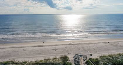 Modern oceanfront condo with outdoor pool, balcony, & washer/dryer