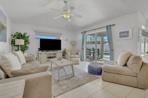 Contemporary coastal escape with heated pool, fenced yard, & outdoor dining