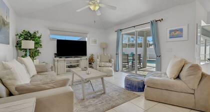 Contemporary coastal escape with heated pool, fenced yard, & outdoor dining