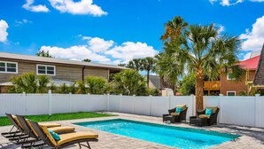 A swimming pool with lounge chairs and a white fence. - Home 1 Block from 2 Beaches w/Private Pool, High-Speed WiFi & Central AC (St. Augustine)