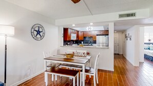Une cuisine moderne avec des meubles en bois, un four encastré et un réfrigérateur.