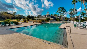 A swimming pool with a 4 ft no diving sign, surrounded by lounge chairs and palm trees. - Spacious condo with pool, hot tub and private washer/dryer (St. Augustine)
