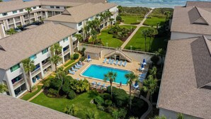 A hotel with a swimming pool, multiple balconies, and a view of the ocean. - Oceanfront rental with amazing views, beach access, pools, tennis & pickleball (St. Augustine)