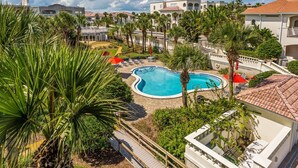 A resort with a swimming pool surrounded by palm trees and lounge chairs. - Lovely ocean-view condo with pools, hot tubs, private W/D, & central AC (St. Augustine)