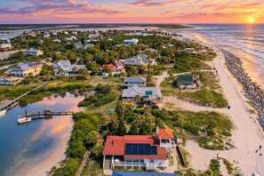 A coastal residential area with houses, a dock, and a beach. - Sunny oceanfront home with balcony, full kitchen, central AC, & washer/dryer (St. Augustine)