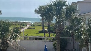 A pool area with lounge chairs and umbrellas, a clear view of the ocean, and a well-maintained lawn. - Crescent Beach Retreat, Partial Ocean View, Heated Pool, Tennis & Pickleball (St. Augustine)