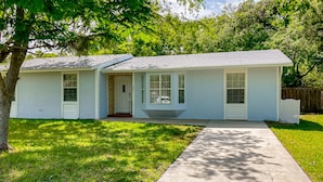A single-story house with a front porch, a covered entryway, and a small front yard.