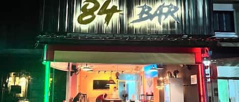 A bar with a prominent number sign and a red awning.