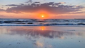 A beach with a sunset over the ocean, waves, and a clear sky. - Lower Level 1 Block from 2 Beaches w/Private Pool, High-Speed Wi-Fi (St. Augustine)