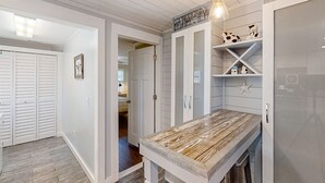 A kitchen with white cabinetry, a wooden countertop, and a hanging light fixture. - Pet -Friendly Home Walking Distance to Down St Augustine (St. Augustine)