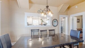 A dining area with a dark wooden table, four chairs, and a hanging light fixture. - Pet -Friendly Home Walking Distance to Down St Augustine (St. Augustine)