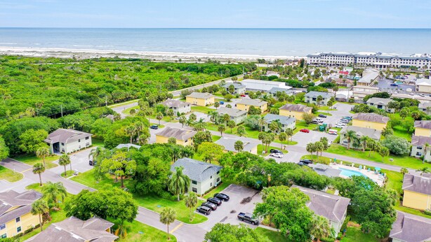 A coastal residential area with a large hotel complex, green spaces, and a swimming pool. - Charming Condo w/ Pool – 500 Yards to Beach, Near Lighthouse & Downtown (St. Augustine)