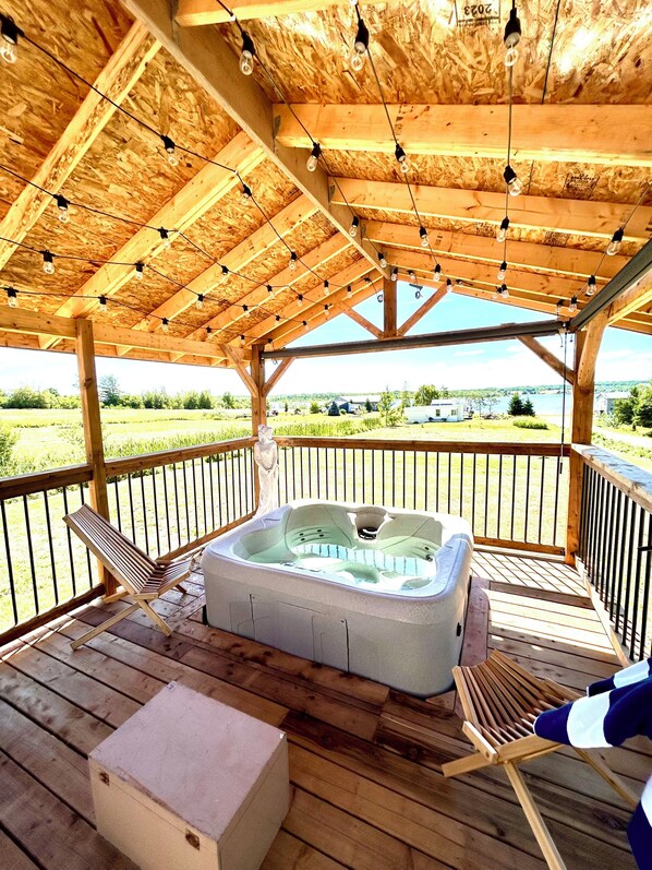 Outdoor spa tub - Coastal Charm Meets Country Calm | Relaxing Cottage with Water Views & Hot Tub (Cocagne)
