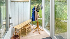 A glass-enclosed room with a wooden bench, a clothing rack, and a basket. - Awesome home in Humble with WiFi (Humble)