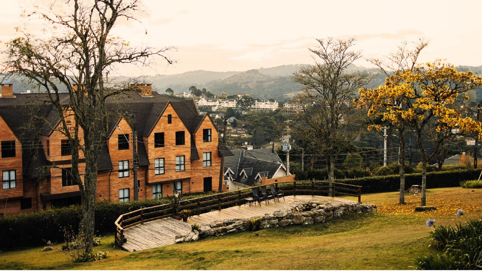 A traditional wooden house with a stone pathway leading to a wooden deck.