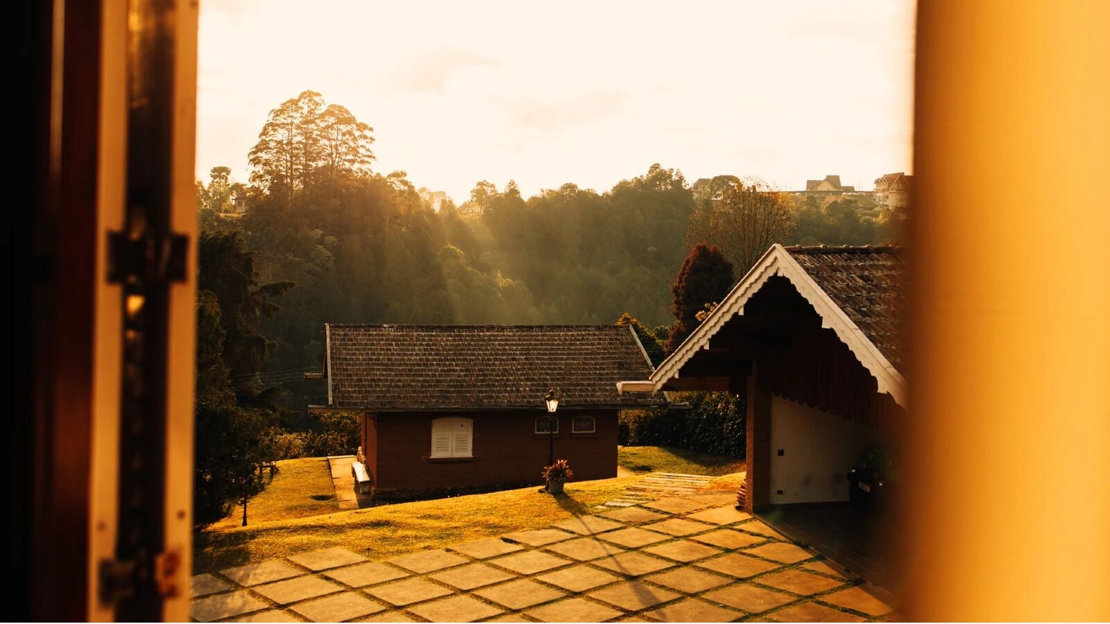 A traditional house with a tiled patio and a small garden.