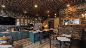 A bar area with a wooden ceiling, green bar stools, and a sign reading "The Trailhouse". - *New* Speakeasy Highlands 7BR | Hot Tub | Sleep 14 (Louisville)