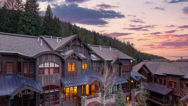 A large, multi-story lodge with a prominent stone facade, large windows, and a complex roof structure. - Ski In Out Villa 464 I Private Hot Tub I Great Views I Outdoor Fireplace I Discounted Attractions (Winter Park)