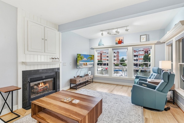 Open Living with Soundside Views — Relax in the bright, coastal-inspired living room where large windows frame stunning water views.