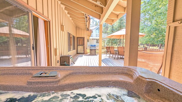 A hot tub with a wooden deck, a grill, and outdoor furniture. - Big Leaf 4 - SHARC, Hot Tub, Ping Pong (Sunriver)