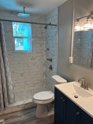 A bathroom with a shower, toilet, and sink. - East Bay Bungalow Less Than 1 Mile to Tyndall AFB (Panama City)