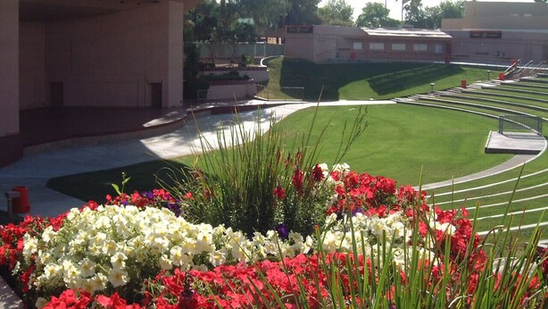 A landscaped area with a building, a grassy field, and a paved walkway. - Clean Quiet Condo - Reliable AC - Downtown Mesa - Free Parking (Mesa)