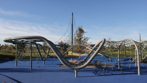 A playground with a climbing structure and netted area. - Clean Quiet Condo - Reliable AC - Downtown Mesa - Free Parking (Mesa)