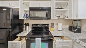 A kitchen with a microwave, stove, refrigerator, and a blender. - Clean Quiet Condo - Reliable AC - Downtown Mesa - Free Parking (Mesa)