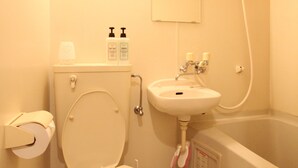 A bathroom with a toilet, sink, and bathtub.