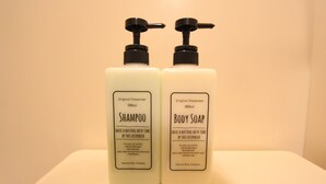 Two bottles of natural hair cosmetic and body cosmetic with pumps, each labeled as 600ml.
