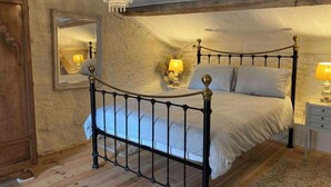 A bedroom with a four-poster bed, a chandelier, a mirror, and a nightstand with a lamp. - 3Bedrooms-Sleeps6-WiFi-Fireplace (Ceaux-en-Loudun)