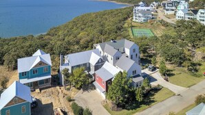 A residential area with houses near a lake, featuring a tennis court and a driveway. - Shore Enough | Carlton Landing Lakeview, Up to 18 (Eufaula)
