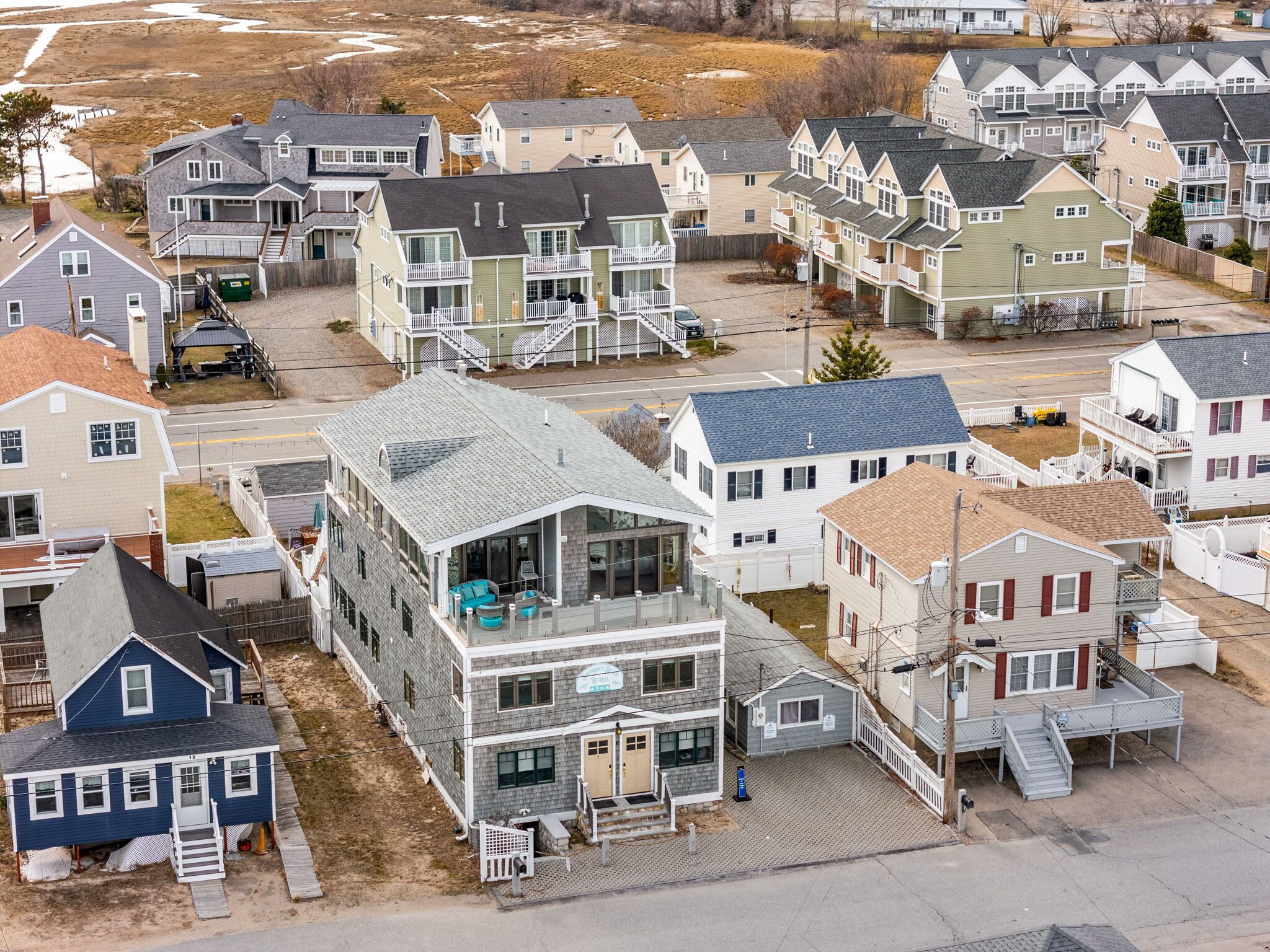 A residential area with multiple two-story houses, some with balconies and front porches.