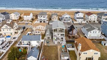Aerial view of the home! Just steps to the beach via a private beach access. The backyard space is shared with other units on the property