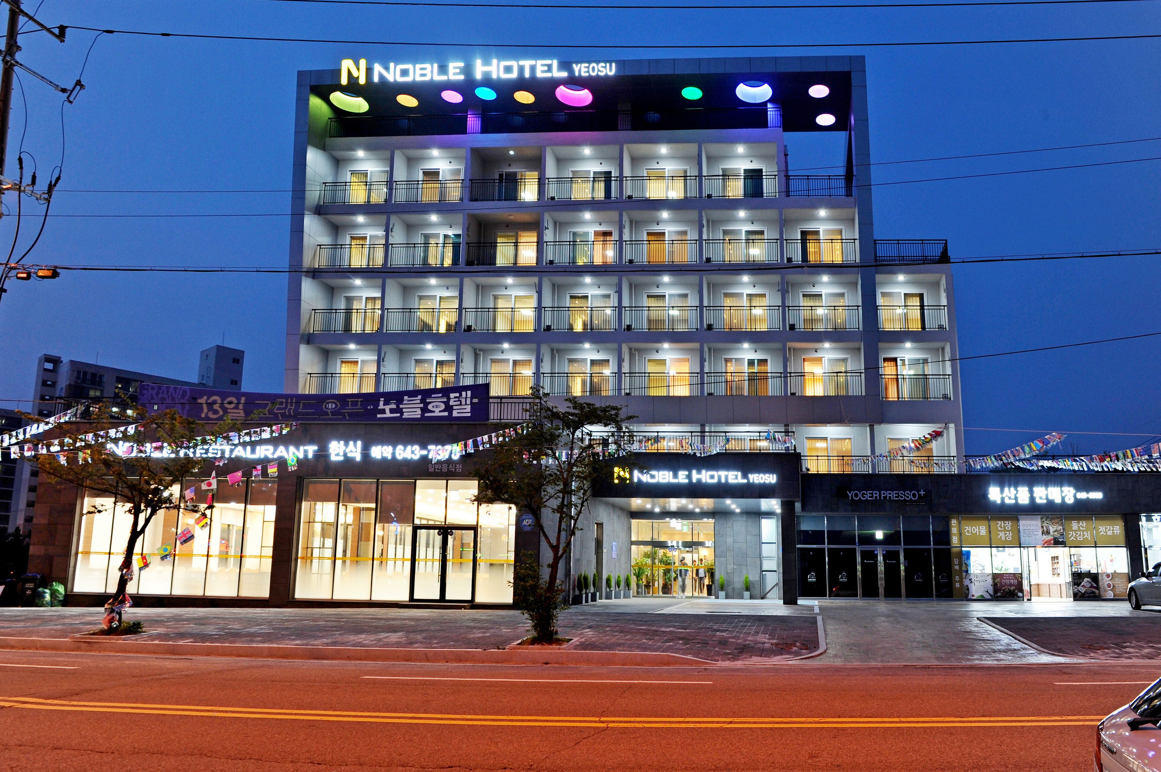 A multi-story hotel with a prominent sign for the Noble Hotel Yeosu.