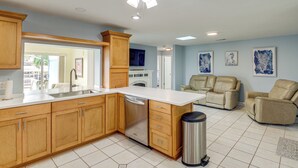 A kitchen with wooden cabinets, a dishwasher, and a ceiling fan. - Canal-Front Retreat w/ Boat Dock on Merritt Island (Merritt Island)