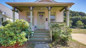 A two-story house with a front porch, a door with a window, and a small front yard with potted plants. - Franklin Home w/ Deck, Creek Views: Walk to Shops (Franklin)