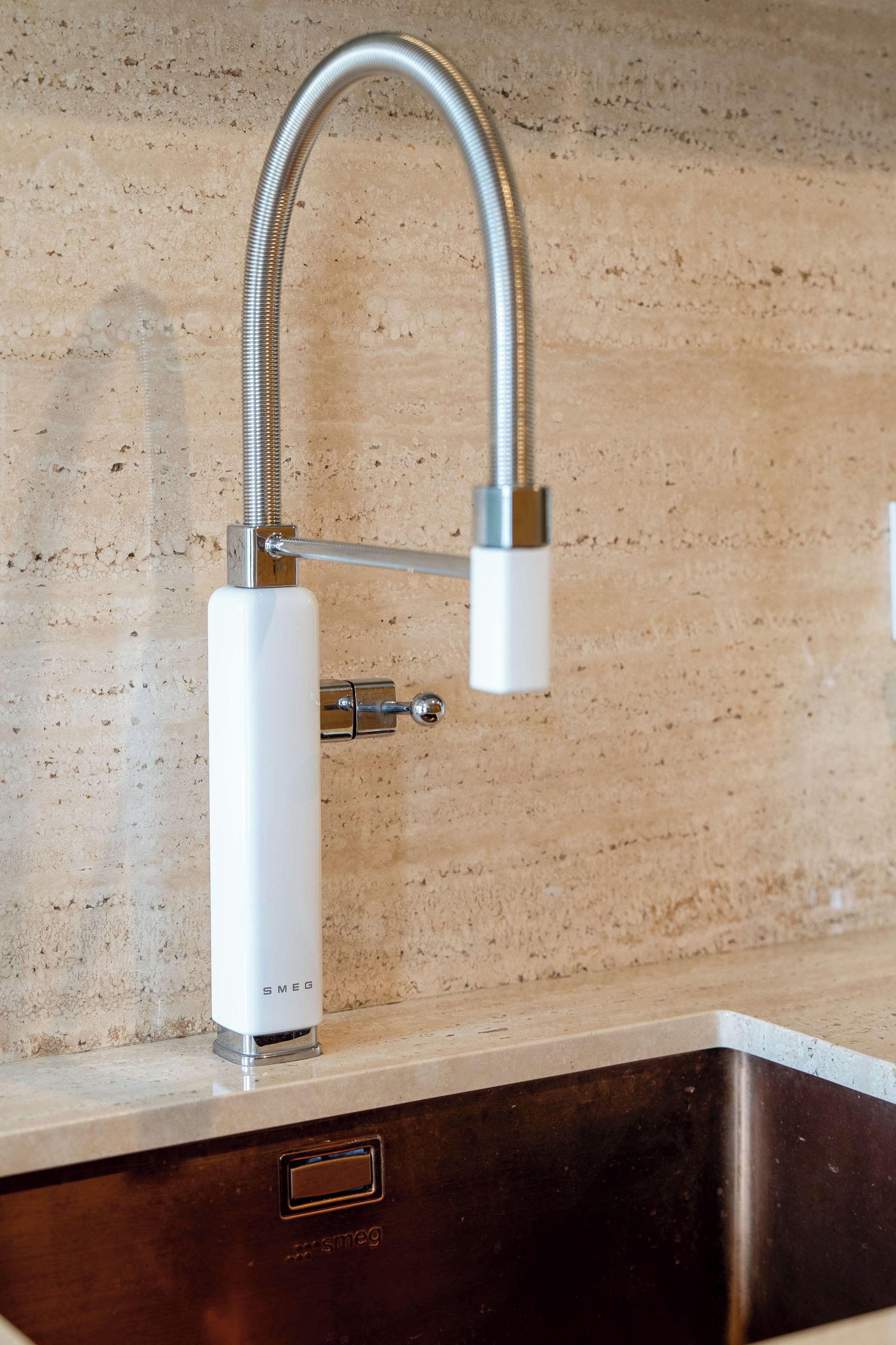 A kitchen sink with a modern faucet and a stainless steel basin.