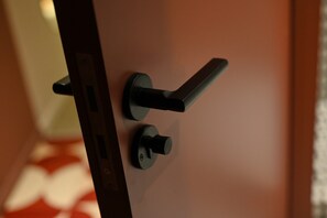 A door handle and lock mechanism. - Nomad Camp (Kaji-Say)