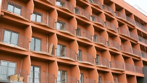 A multi-story building with balconies and windows. - Nomad Camp (Kaji-Say)