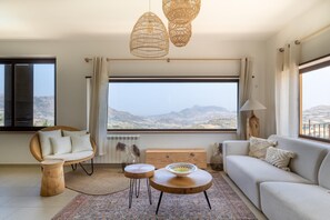 A modern living room with a view of a mountainous landscape. - Sundrenched Sicilian Villa - Pool, Hot Tub, Gym, Sauna - Sleeps 10 Near Palermo (Ciminna Palermo)