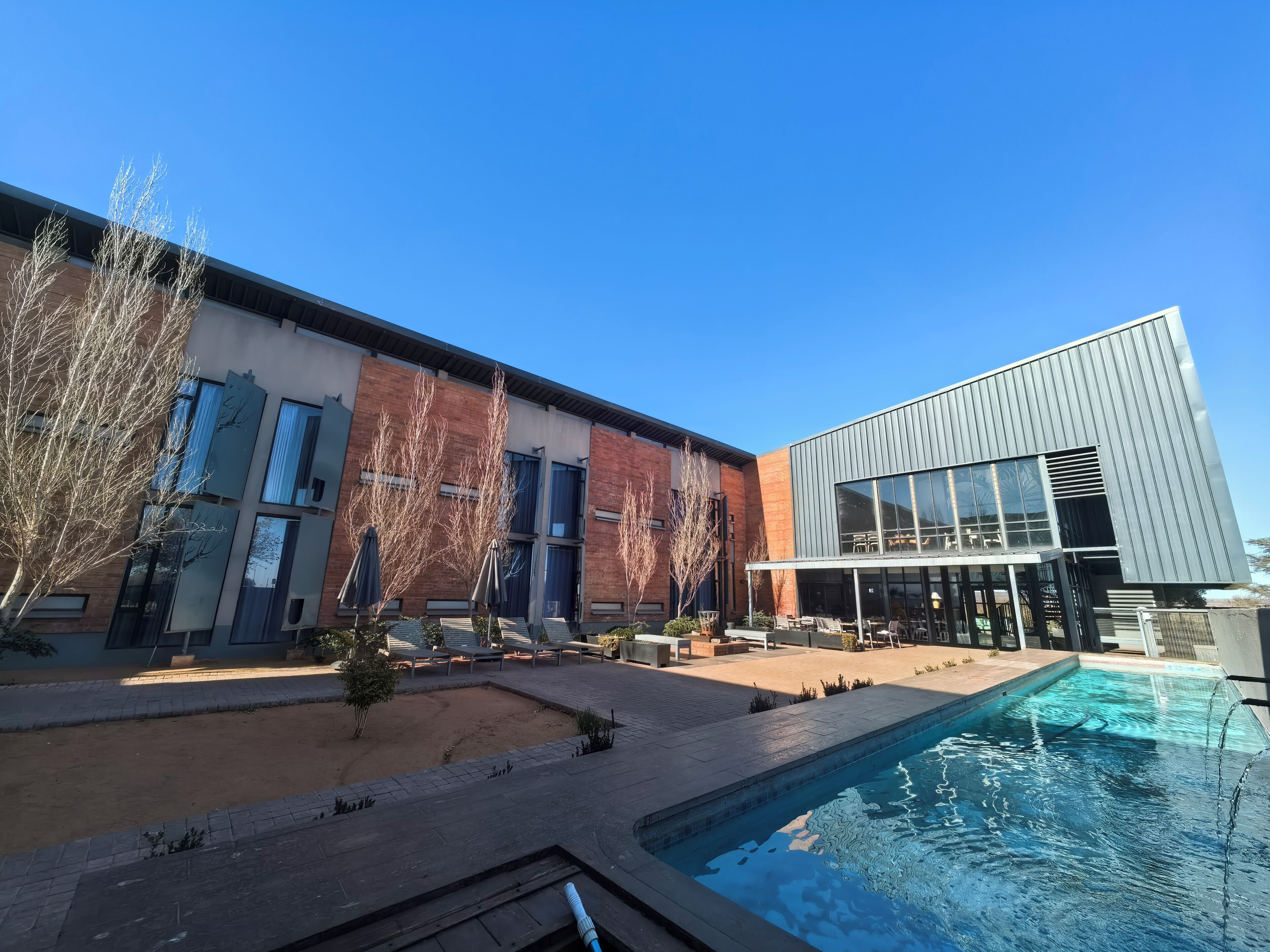 Outdoor pool, pool umbrellas, sun loungers