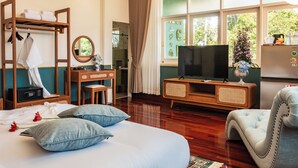 A hotel room with a bed, a desk, a television, and a chair. - Chez Nij Ryokan Onsen (Chiang Mai)