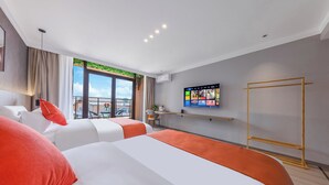 A modern hotel room with a large bed, a TV mounted on the wall, and a balcony with a view. - Yi Jia Hotel (Kunming)