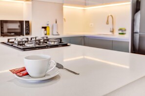 Fridge, microwave, stovetop, coffee/tea maker