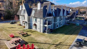 A multi-story building with a symmetrical roofline and multiple balconies. - Ski, Bike, Golf, Repeat (Kimberley)